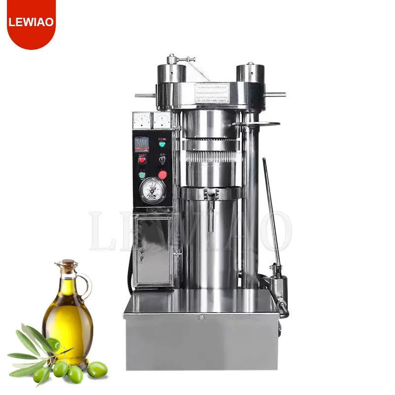 alt="A compact hydraulic cold press machine for coconut oil, with fresh shredded coconut being loaded into fabric filter bags stacked between metal plates, and golden oil dripping into a collection tray.">