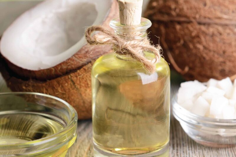 alt="Organic virgin coconut oil in a glass jar with fresh coconuts.">